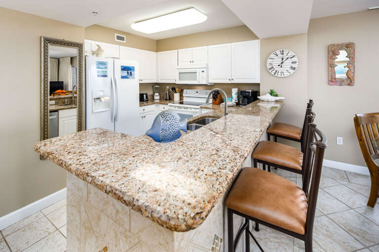 Granite counter tops and decorative tile work make the kitchen look as elegant as it is functional.