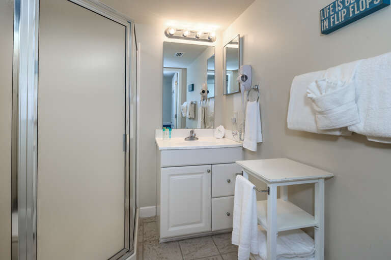 Another full bathroom with walk-in shower accessible from the hallway