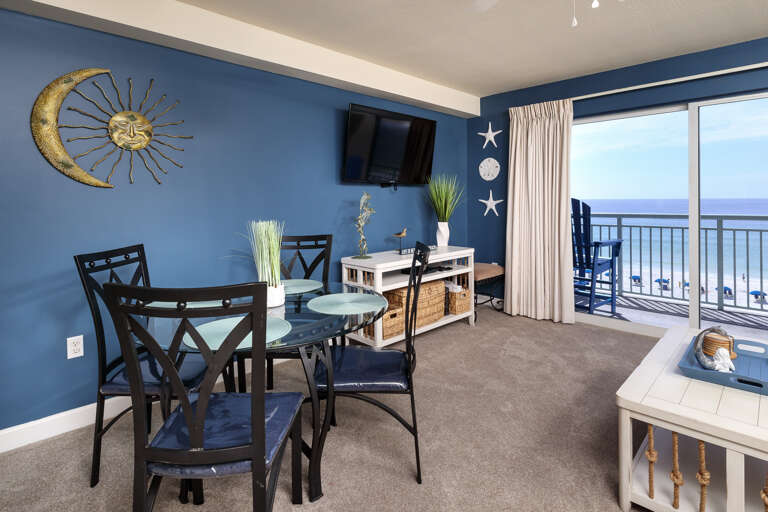 Views of the gorgeous Emerald Coast seen from the living room, dining area, and kitchen of this condo.