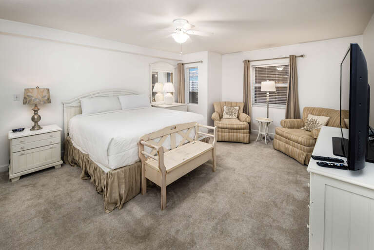 Unwind after a fun filled beach day in this luxurious master bed. Comfy recliners for extra seating