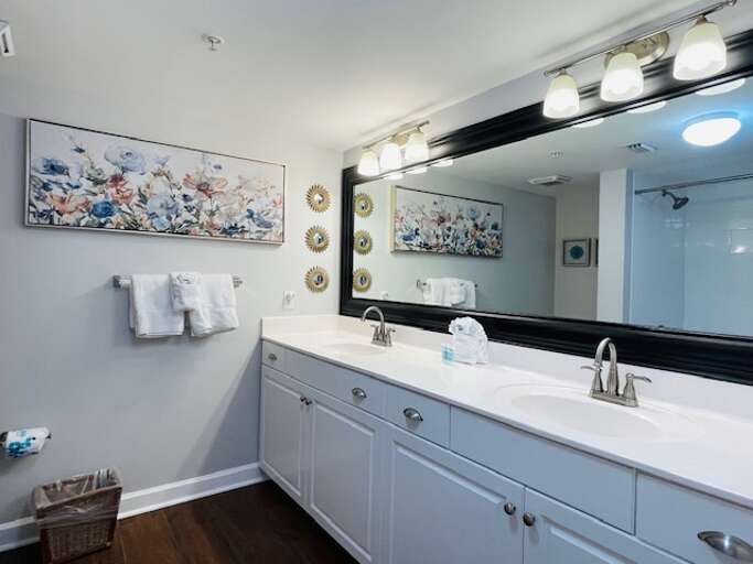 Master bath boasts double sinks and a tub/shower combo.