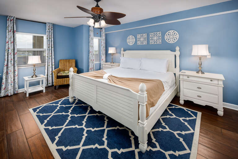 Beachy Bliss: Bright blue walls complement stylish decor in this inviting bedroom retreat!