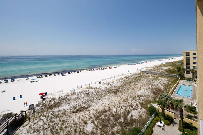 The crystal green-blue waters are a beautiful backdrop to this very charming 1BR/2BA beachfront condo on Okaloosa Island.