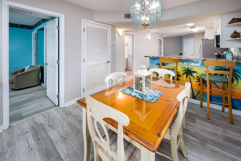 The dining table seats 4 with more seats at the breakfast bar