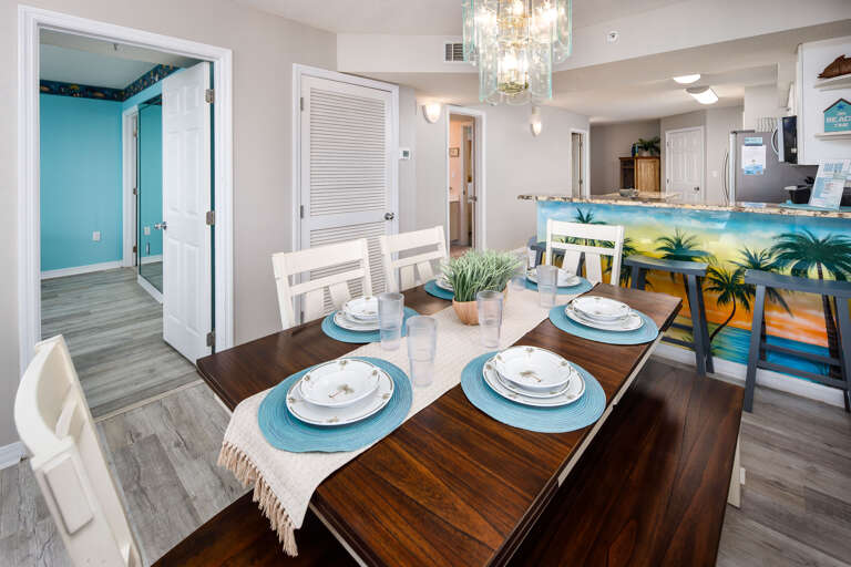 The dining table seats 4 with more seats at the breakfast bar