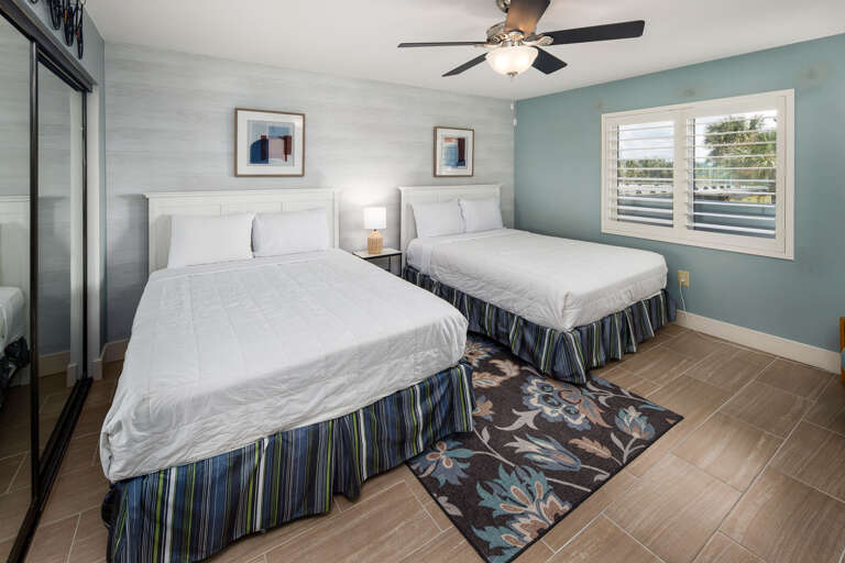  This spacious lovely guest bedroom with TWO QUEEN size beds now features Tile Flooring making for a perfect beach-front accommodation!!