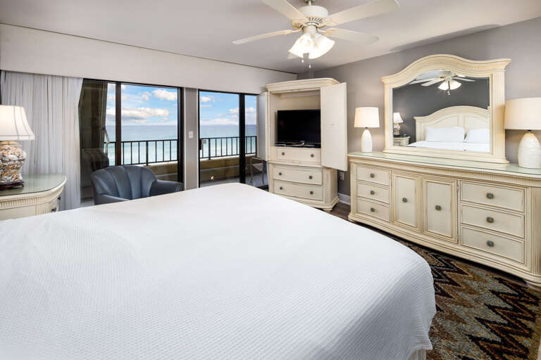 Large balcony doors really let the sights and sounds of the Gulf encompass all of this master bedroom.