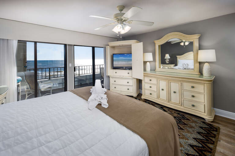 Large balcony doors really let the sights and sounds of the Gulf encompass all of this master bedroom.