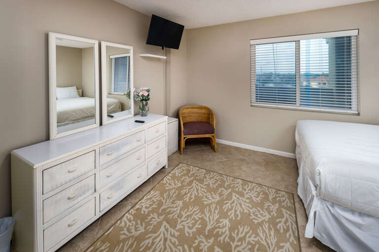 Wall mounted TV and dresser for plenty of space to put your belongings.