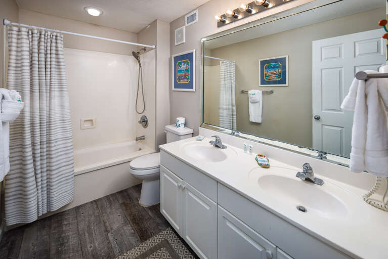Large vanity featuring two sinks.