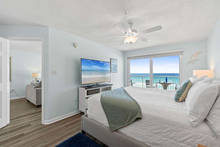 Facing a flat screen TV with a private bathroom to the side