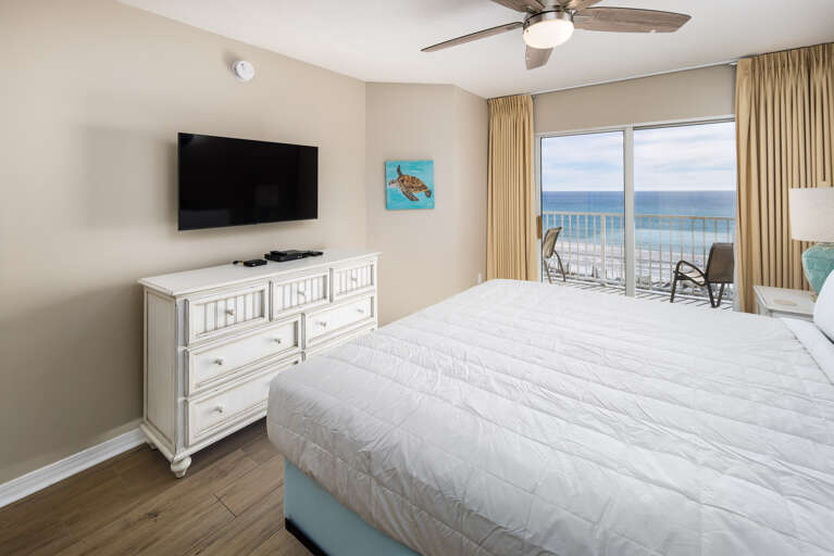 King size bed in this beachfront master bedroom with private entrance to the balcony