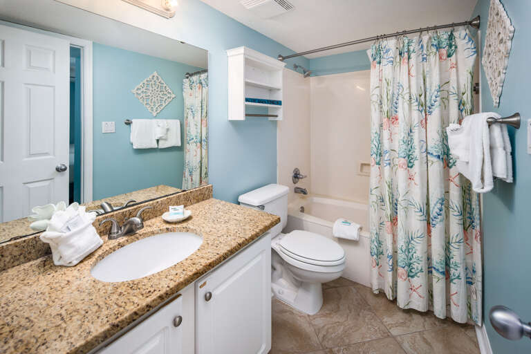 Beautiful granite counter top, extra room for hanging towels and coastal shower curtain add to the list of recent upgrades in Gulf Dunes 412!