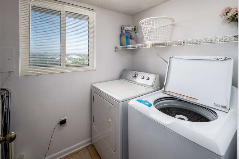 In a separate laundry area off the kitchen
