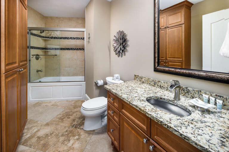 A guest bathroom with shower and tub combination.