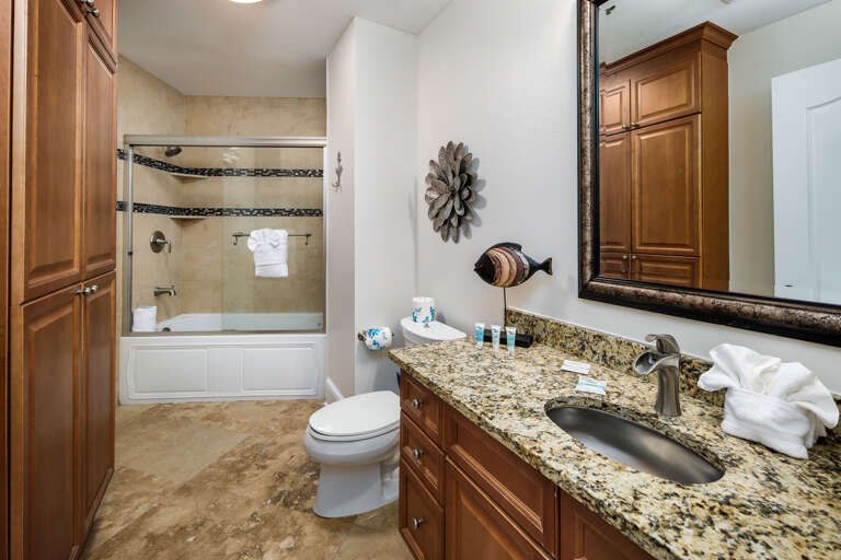 A guest bathroom with shower and tub combination.
