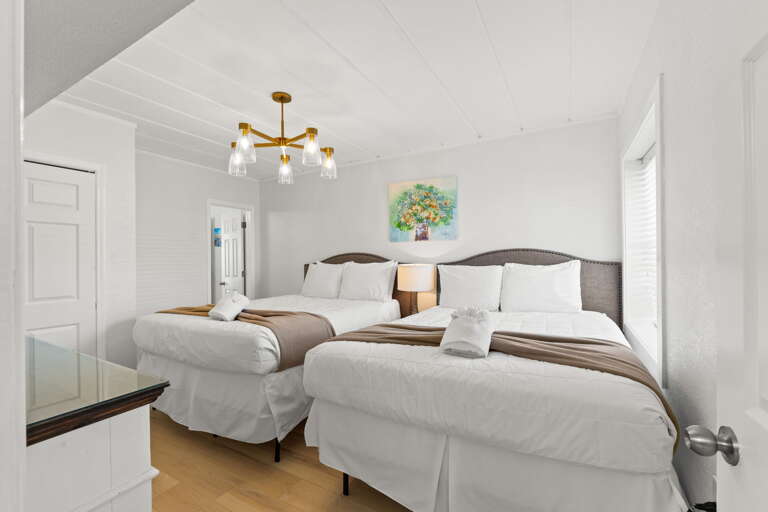 Features two queen beds and shares a bathroom with the 2nd master bedroom.