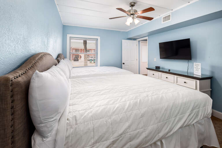 Both beds facing a flat screen TV