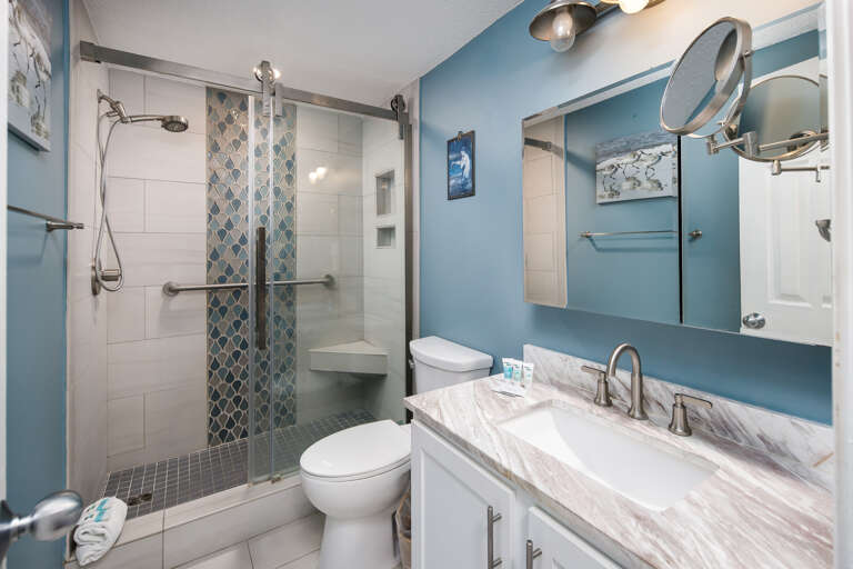 Beautiful clear glass enclosure in this bathroom; perfect for unwinding after a long day on the beach!