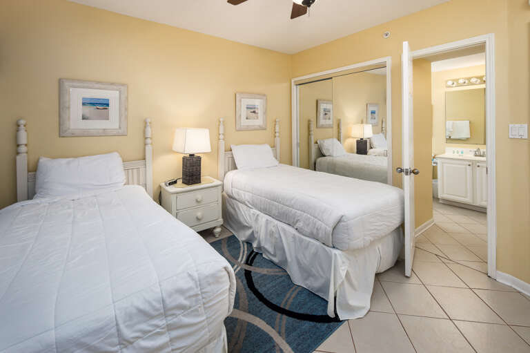 Facing a flat screen TV with a private bathroom to the side 