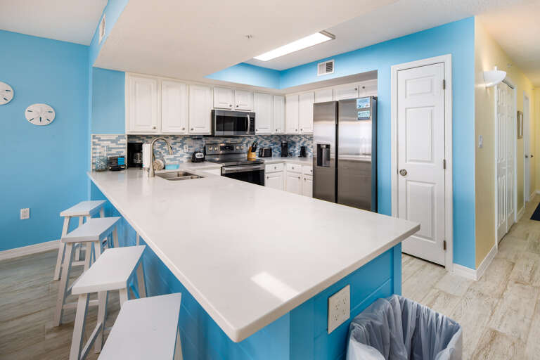 Fully stocked kitchen with ample space on the quartz counter tops for meal preparations and added space for entertaining.