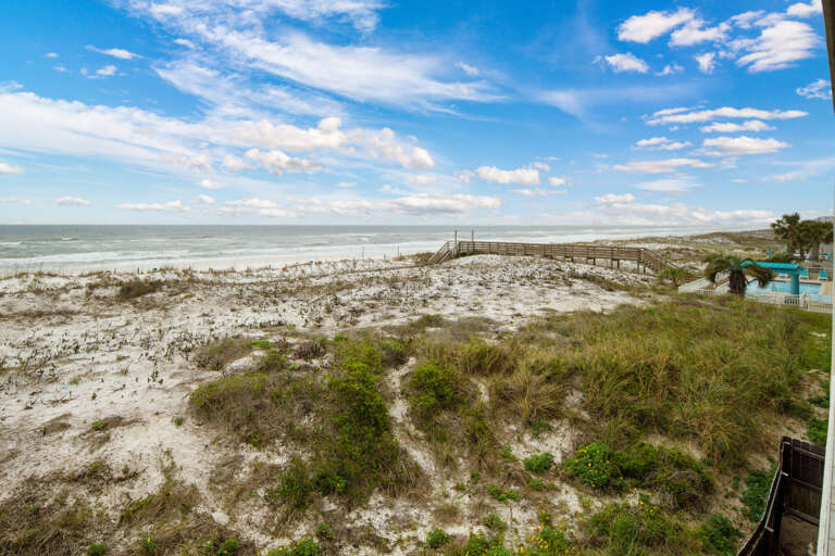 Just past the dune is the beach!  White sand & emerald water!