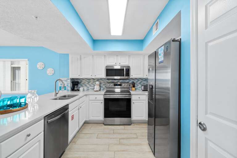 Bright and airy view of the Kitchen enhanced by the Stainless Steel appliances makes meal prepping effortless.