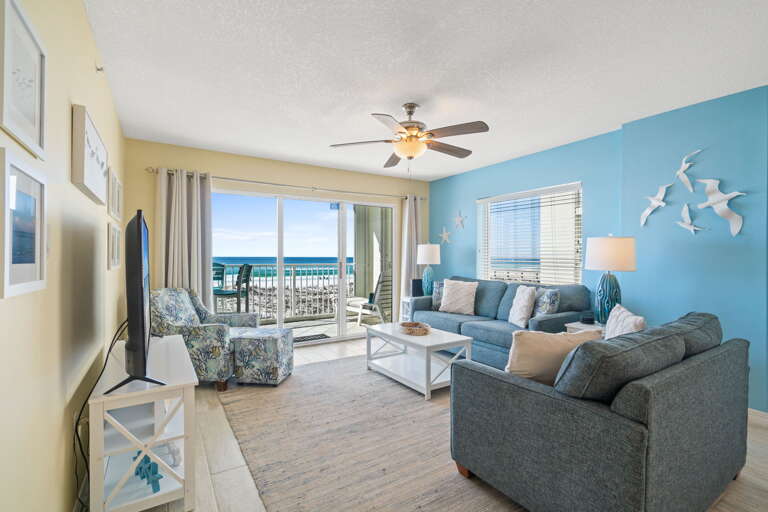 Spacious and welcoming view of the living room and the balcony.