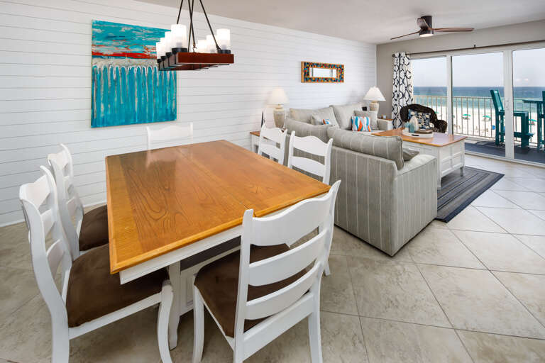 Comfortable floor-plan allows the kitchen to open to the dining AND family room areas...in the background is the Gulf..and entry to your front private balcony.