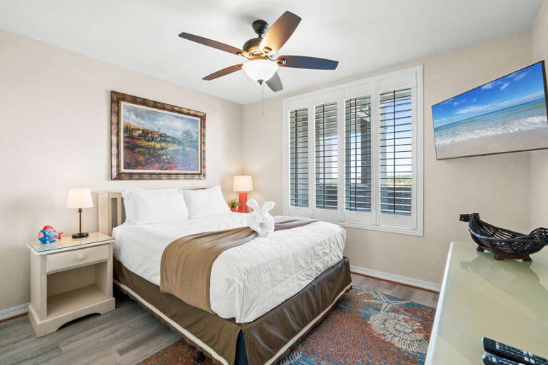 Beautiful plantation shutters are a nice touch to this bedroom.   