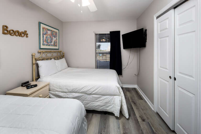 Both beds face a mounted TV for all your viewing pleasure 