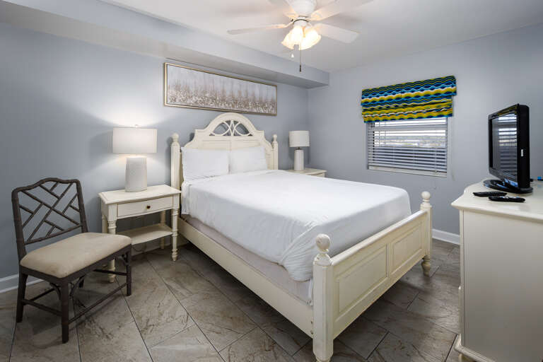Guest bedroom features a comfy queen size bed and a flat screen.