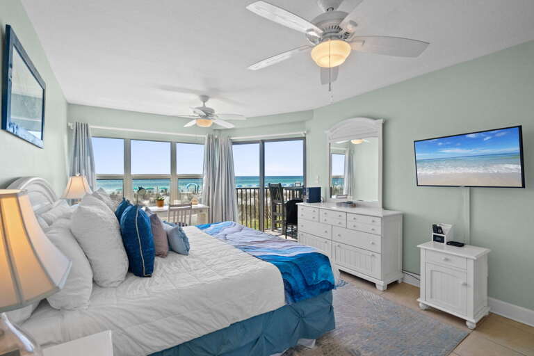 Large balcony doors really let the sights and sounds of the Gulf encompass all of this master bedroom.