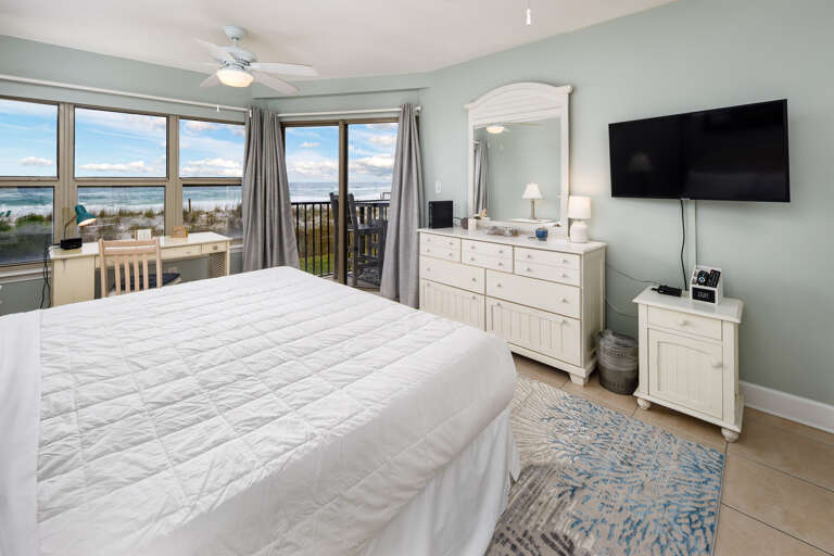 Large balcony doors really let the sights and sounds of the Gulf encompass all of this master bedroom.