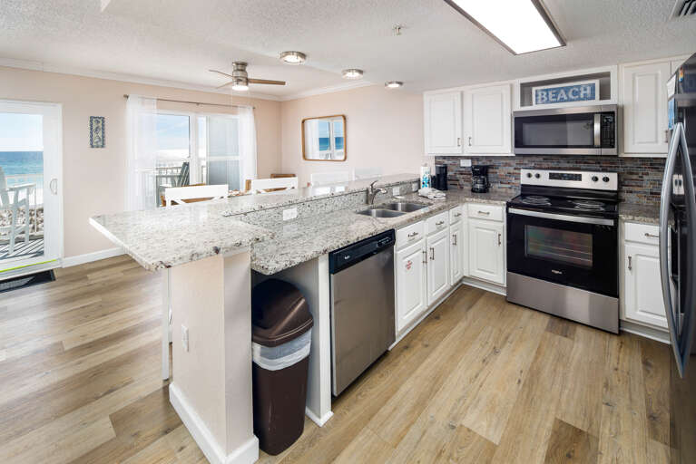 Full service kitchen with granite countertops and stainless steel appliances 