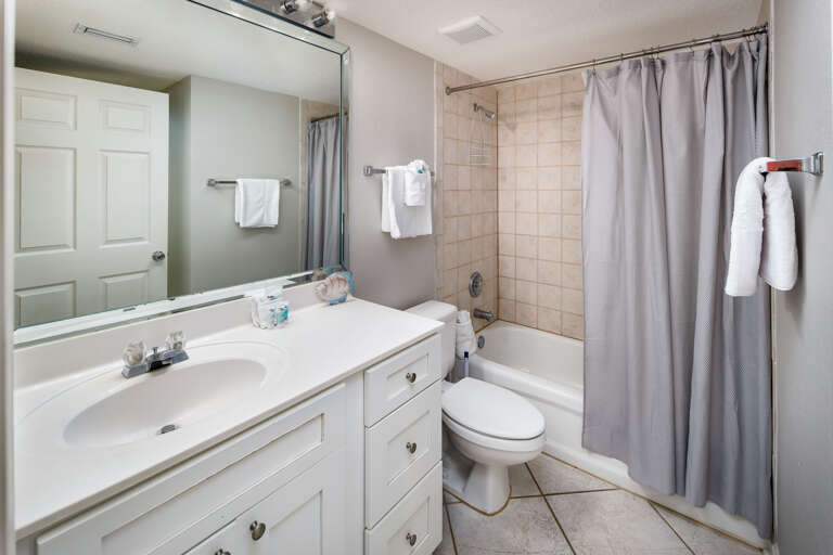 The second bathroom has a shower tub combination 