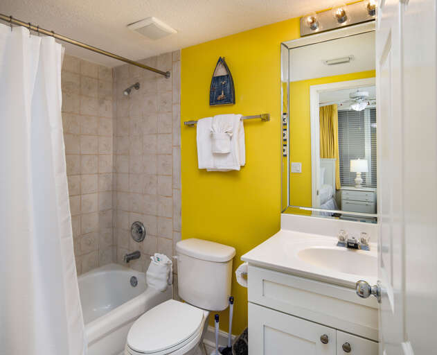 The third bathroom features a shower tub combination