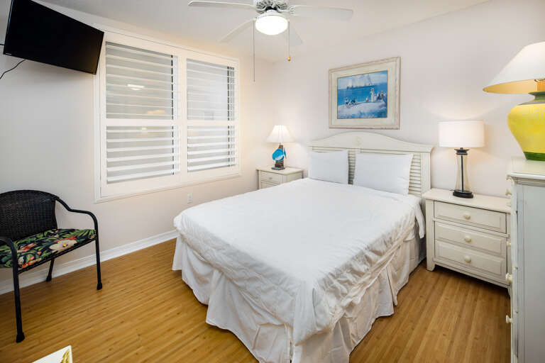 The first guest bedroom features a queen bed. 