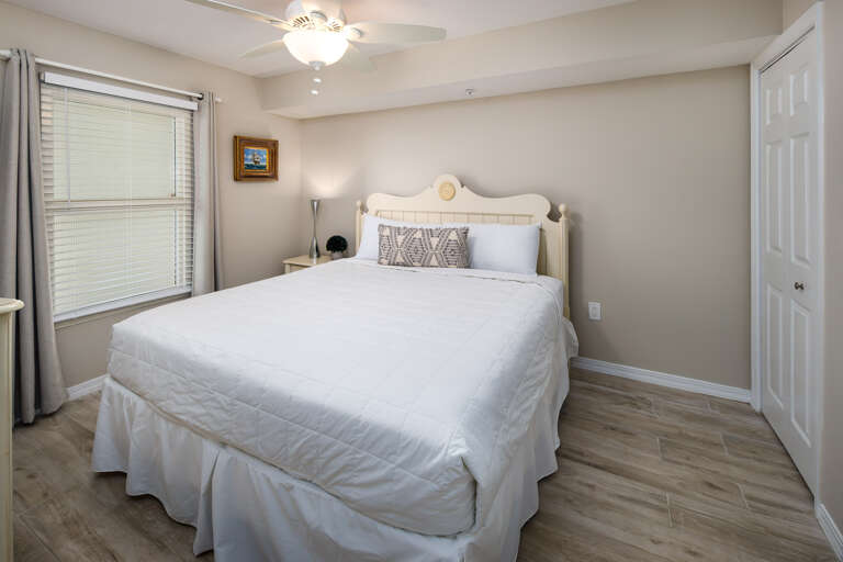 This guest bedroom has a king size bed and access to a bathroom