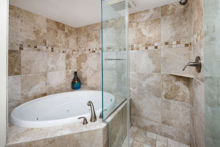 A walk in shower and tub in this master bath
