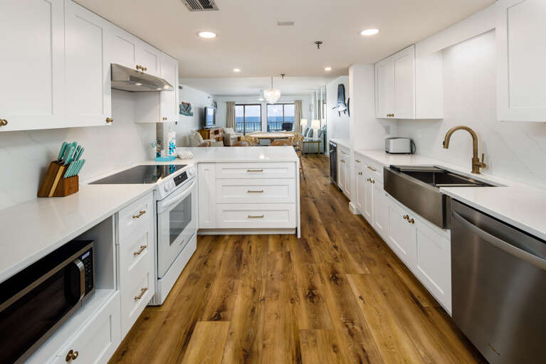 Gorgeous open kitchen! with beautiful white cabinets and counter tops! 