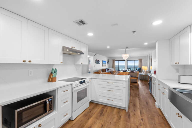 Gorgeous open kitchen! with beautiful white cabinets and counter tops! 