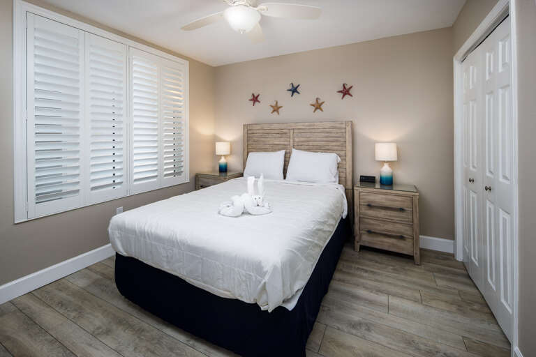 A queen bed is featured in the first guest room!