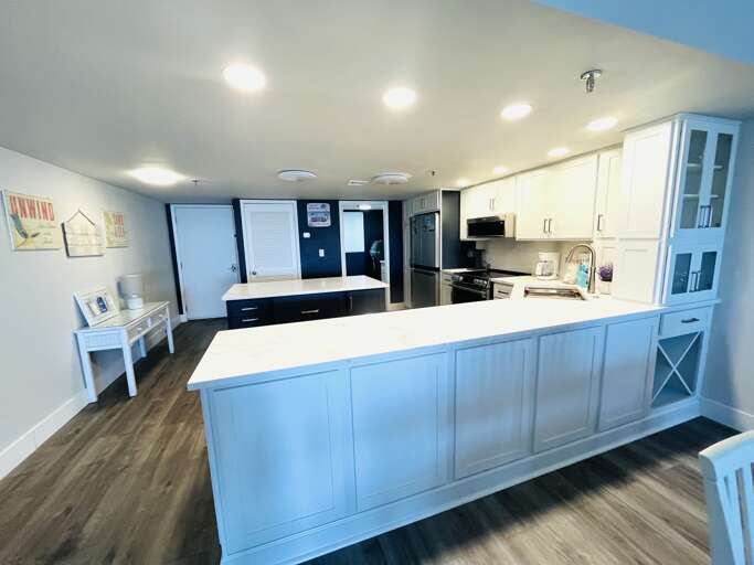 Warm, welcoming kitchen with marble counters and an island—ideal for easy meals.