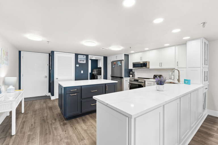 Bright, updated kitchen with elegant marble surfaces and an island for gathering.