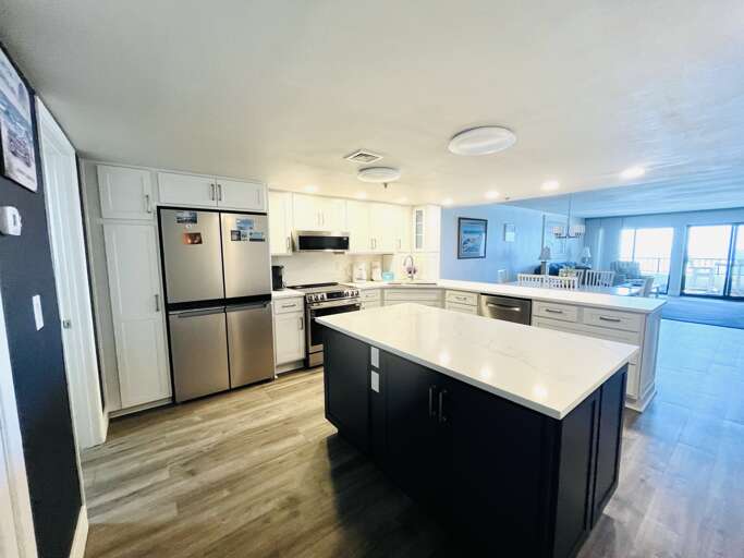 Bright, updated kitchen with elegant marble surfaces and an island for gathering.