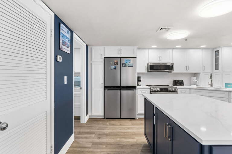 Warm, welcoming kitchen with marble counters and an island—ideal for easy meals