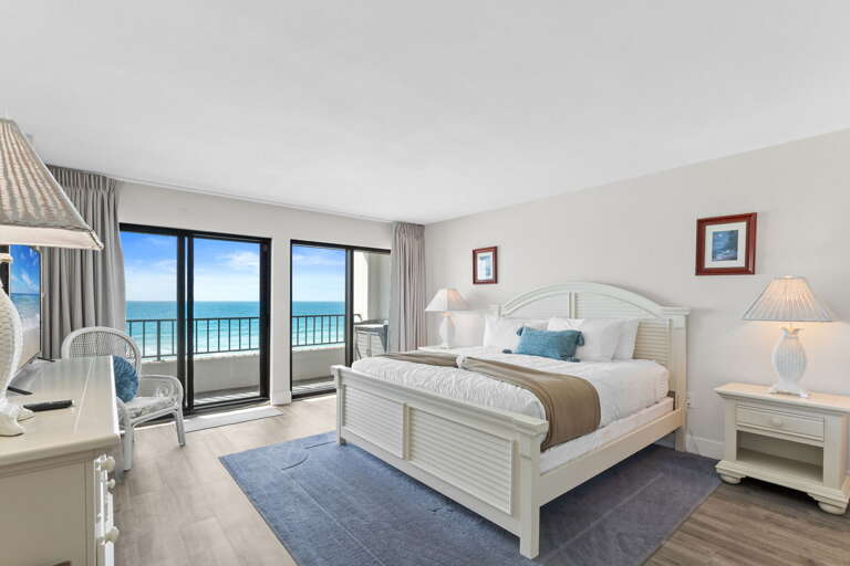 Cozy master bedroom with a king bed and direct access to the balcony.