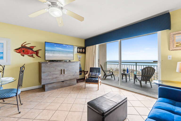 Enjoy this living room decorated with pops of colors, tile flooring & a great view!