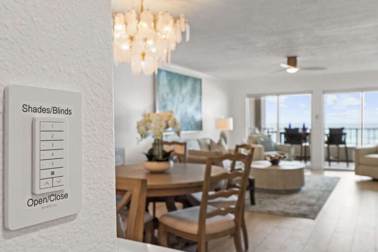 Located on the wall next to the kitchen island, you will find the controls to raise and lower the window shades in the living room.